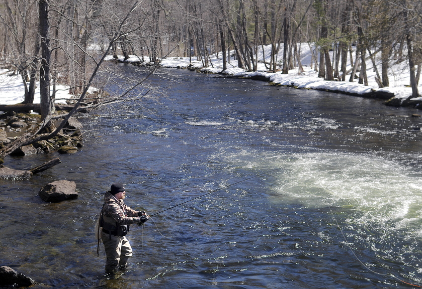 Travis Parlin, of Fairfield, casts a set of nymphs into Cobbosseecontee Stream on Tuesday in Manchester beneath a clear sky. Anglers planning to toss a line into other bodies of water across the state that open Wednesday with the commencement of fishing season will encounter similar conditions, according to the National Weather Service, with plenty of sun and temperatures in the upper 30s.  Parlin said he’s been addicted to connecting flies and fish since he was a freshman in high school.