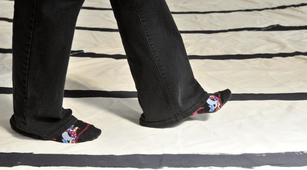 Jenifer Lewis walks around the labyrinth on Friday in the Winthrop Center Friends Meeting House where the St. Andrew’s Episcopal Church meets.