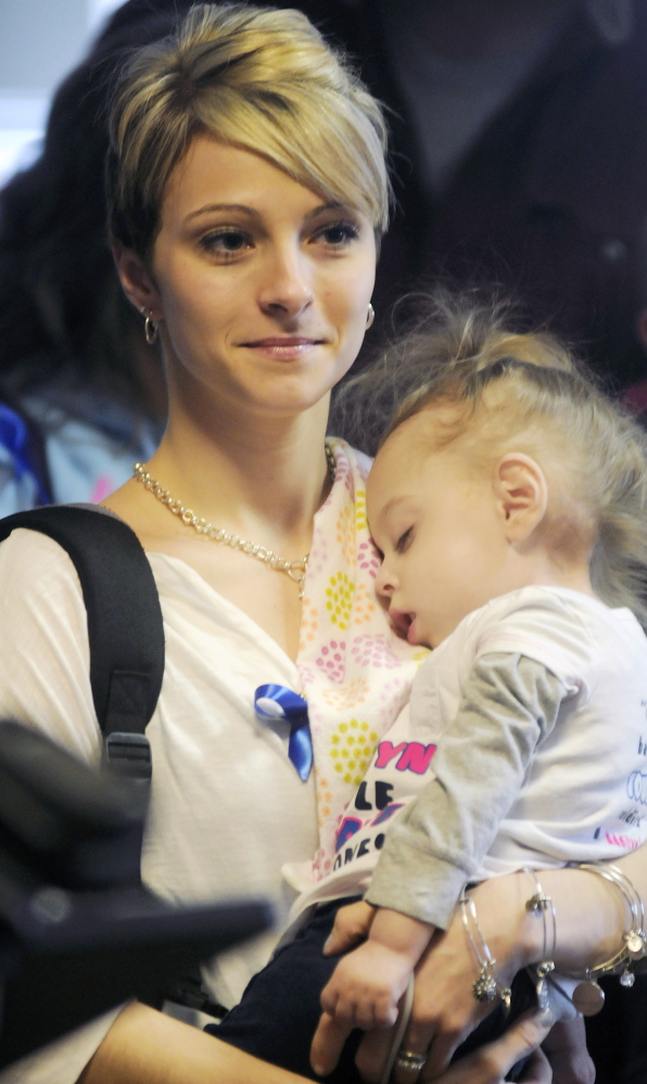 Jamie Davis of New Sharon holds her daughter, Addilyn, on Monday before attending a hearing about a bill requiring screening of newborns for Krabbe’s disease. Davis has raised awareness of the disease, a genetic disorder of the central nervous system, on a Facebook page followed by 107,000 people since her daughter was born with it in 2011.