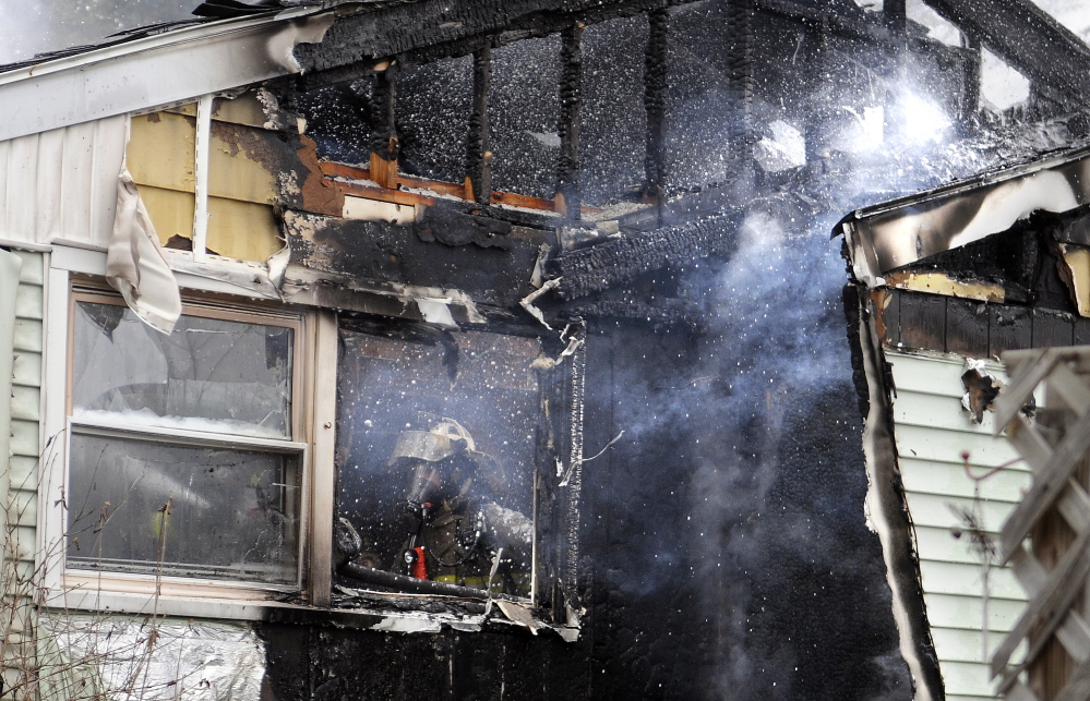 Firefighters extinguish a blaze on Bowman Street Wednesday in Farmingdale.