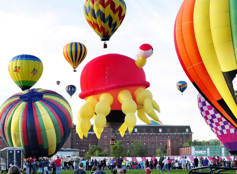 John Patriquin/StaffPhotographer: Friday August 16, 2013. Some of the 20 balloons that took off from Lewiston's Simard-Payne Memorial Park to kick off the 21st Annual Great Falls Balloon Festival. Including the large crab in the center. (Photo by John Patriquin/Staff Photographer)