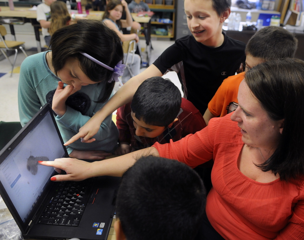 Maine Center for Disease Control and Prevention epidemiologist Sara Robinson shows students at Farrington Elementary School in Augusta microscopic images of mosquitoes. The presentation, held last week, taught students to be wary of diseases spread by insects such as ticks and mosquitoes.