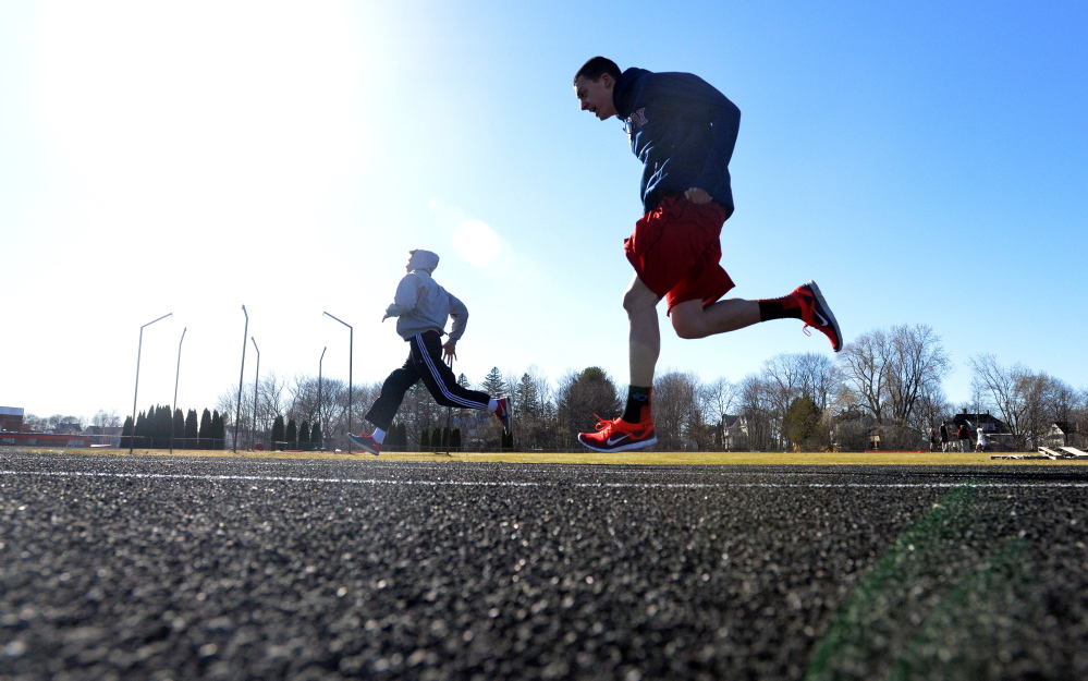 Members of the Thomas College track club work out Wednesday at Winslow High School.