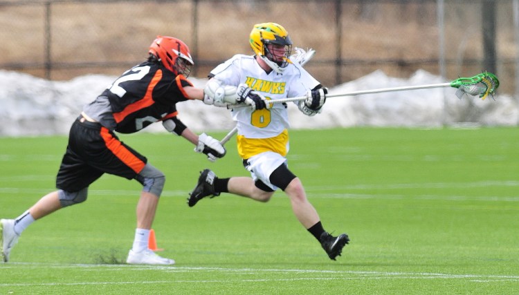 NYA defender Nick Farnham, left, tries to stop Maranacook/Winthrop’s Drew Davis during a game Saturday on Huard Field at Kents Hill School in Kents Hill.