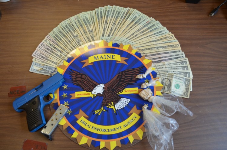 Drugs, cash and a handgun were seized Wednesday during a search of a Washington Street apartment in Augusta.