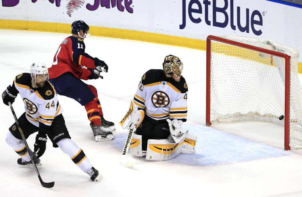 Bruins goalie Tuukka Rask gives up a goal to Florida Panthers center Aleksander Barkov (not pictured) as center Jonathan Huberdeau skates past defenseman Dennis Seidenberg in the second period Thursday night in Sunrise, Fla. The Bruins suffered a costly 4-2 defeat.