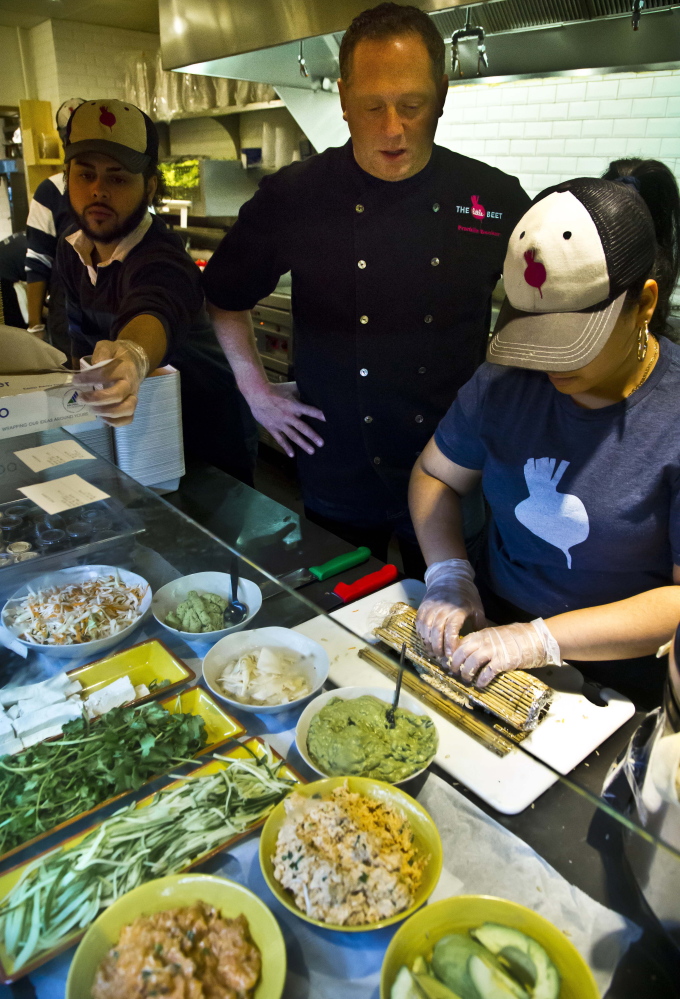 Chef Franklin Becker, center, watches the preparation of a dish at The Little Beet during lunchtime at the restaurant in New York. For years, healthy chains have sputtered and flopped but Becker, who’s opening seven more restaurants in the New York area this year, says the demand is growing. “That’s what people want to eat. They want honest foods now.”
The Associated Press