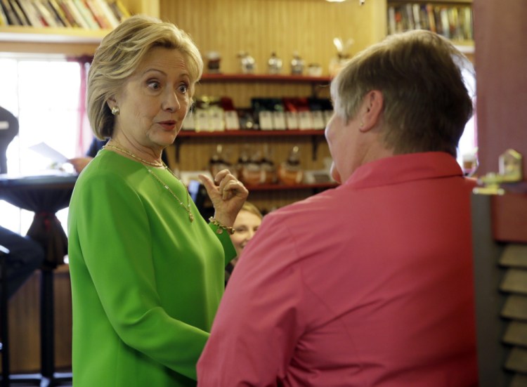 Democratic presidential candidate Hillary Rodham Clinton talks with local residents at the Jones Street Java House in LeClaire, Iowa, on Tuesday.