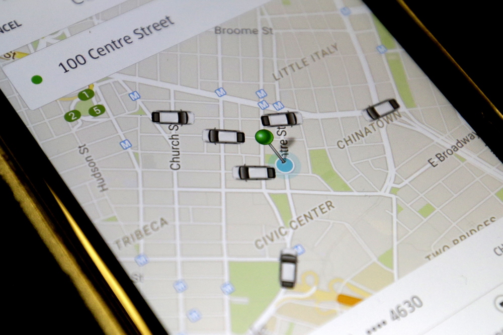 The Uber app displays cars available to make a pickup in downtown Manhattan on a smartphone in New York. Portland is trying to establish rules for the San Francisco-based ride service, which has been operating unregulated in the city since October.