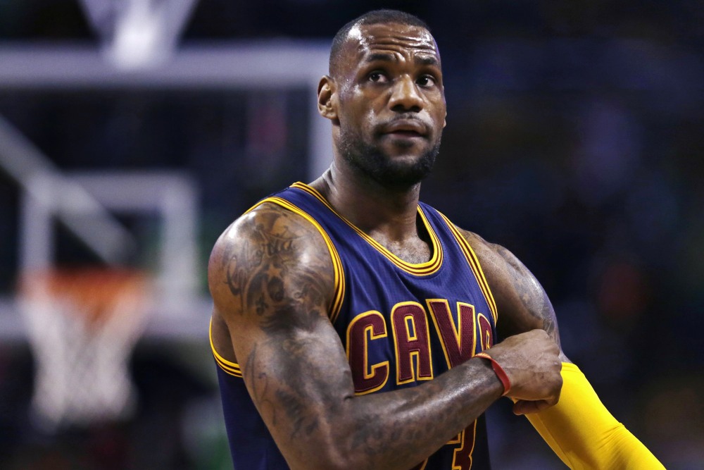 Cleveland Cavaliers forward LeBron James pulls up his sleeve while facing the Boston Celtics in the first quarter of a first-round NBA playoff basketball game in Boston on Thursday.