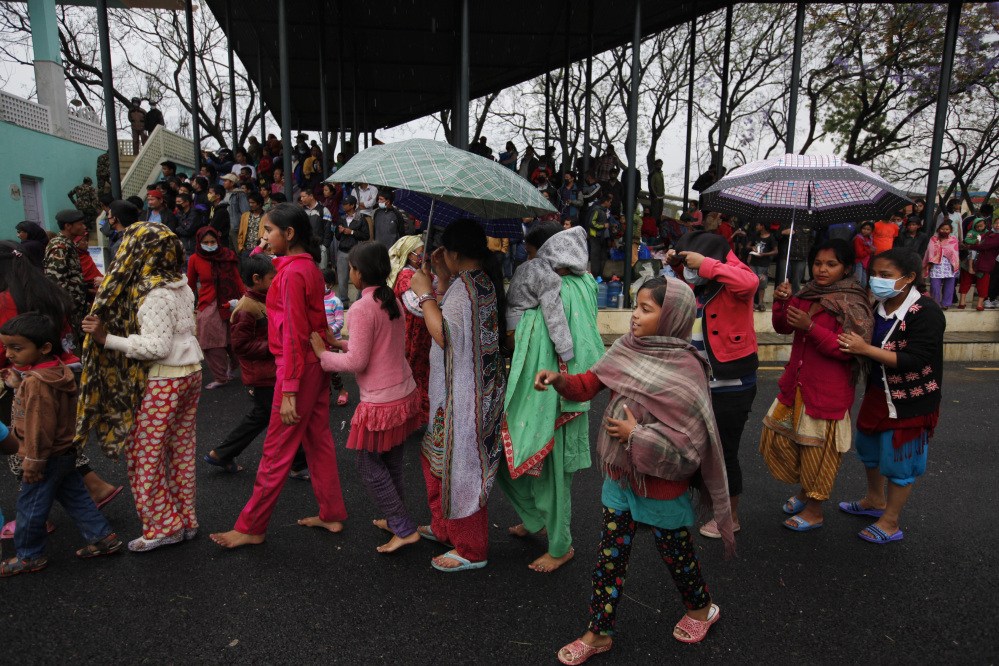 Nepalese victims of an earthquake stand in a queue to receive food in Kathmandu, Tuesday.