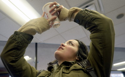 Emily Armstrong of Portland checks to see what her coffee cup is made of Friday at Dunkin’ Donuts in Portland. She is pleased that Dunkin’ Donuts now uses recyclable cups. Shawn Patrick Ouellette/Staff Photographer