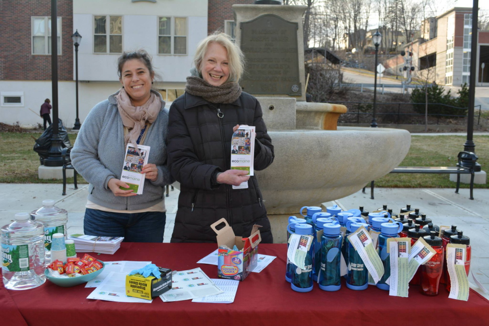 Phyllis vonHerrlich, left, from the Augusta Downtown Alliance’s Design Committee, and Lissa Bitterman, right, from ecomaine help celebrate Earth Day during the Clean & Green Clean-Up event in Market Square Park.