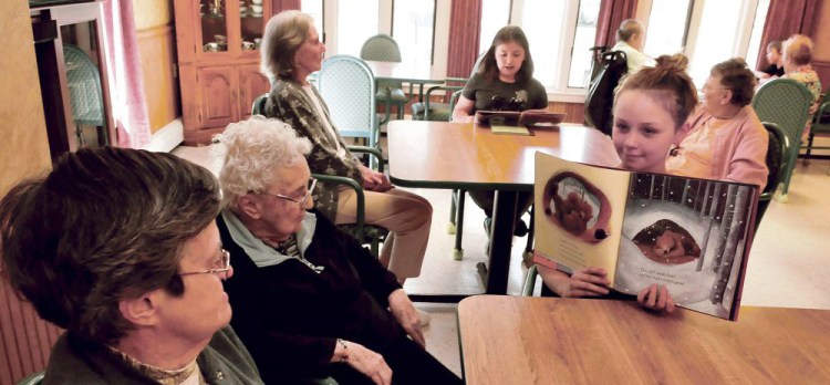 Quimby School student Kelsie Walter reads to residents of the Somerset Rehab and Living Center in Bingham on Tuesday. Students participating in “Screen Free” week don’t use electronic devices and instead go outdoors and engage with community members.