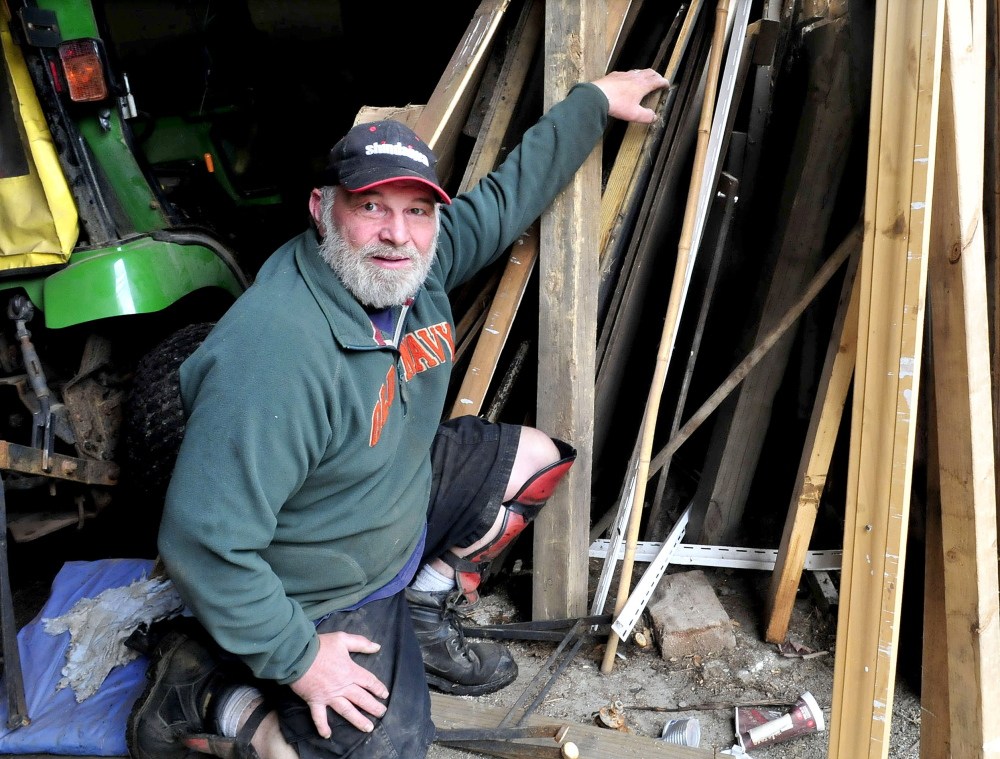 Jim Goodwin shows where he recently found a memorial plaque between building material that was stored at his shop in Benton on Tuesday. The plaque was originally placed on the Gilman Street Bridge in Waterville in honor of former Waterville Mayor Lorenzo Eugene Thayer but was removed some time in the 1960s or ’70s. Goodwin employees removed the plaque from a Waterville home where they were hired to clean and empty the contents 10 years ago.