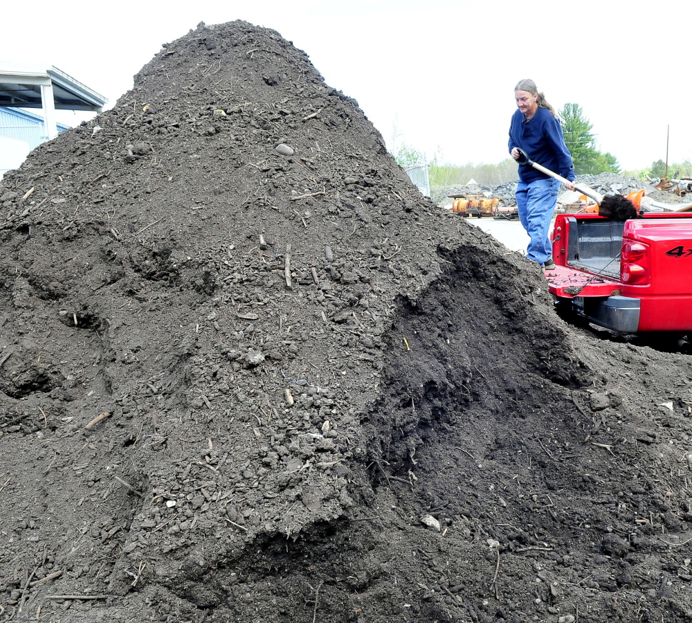 Heather Enos fills her truck bed on Wednesday with compost made at the Skowhegan Regional Recycling Center and made available for residents.