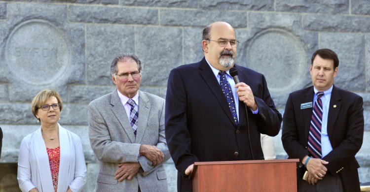 Mayor David Rollins speaks on Thursday during groundbreaking ceremonies for Lithgow Public Library expansion in Augusta. Lithgow Library director Betsy Pohl, left, Wick Johnson and Andrew Silsby, of Friends of Lithgow Library, listen before they all later held gold shovels for a ceremonial toss of sand.