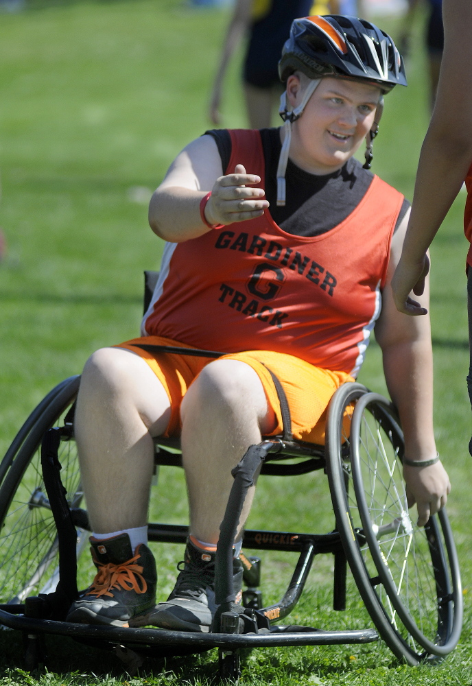 Staff photo by Andy Molloy 
 Gardiner Area High School student RJ Sullivan greets a teammate during a track meet Thursday in Gardiner.
