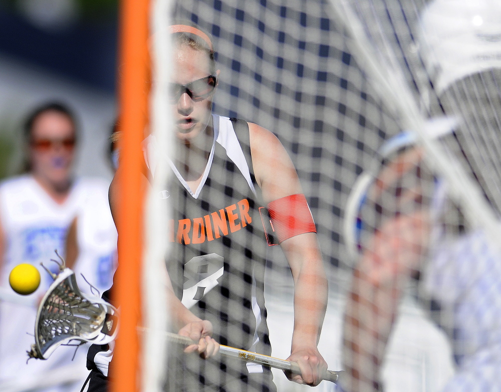 Gardiner Area High School’s Emma Hickey fires a goal past Erskine’s Malorie Weaver during an Eastern B game Tuesday in South China. Gardiner won 14-2.