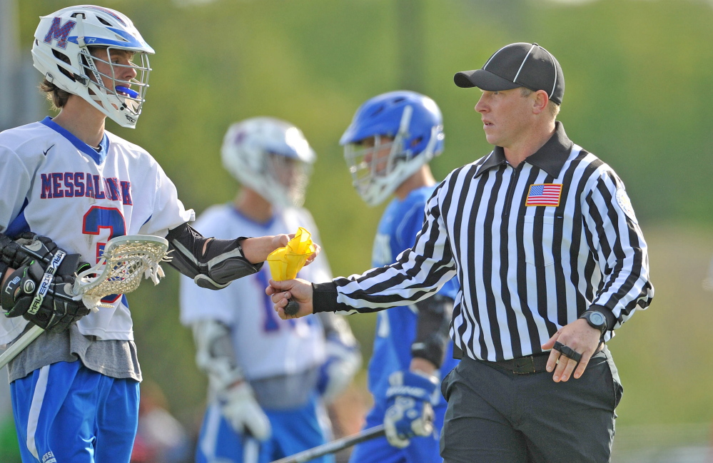 Josh Blaisdell officiates a high school lacrosse game last week at Thomas College in Waterville.