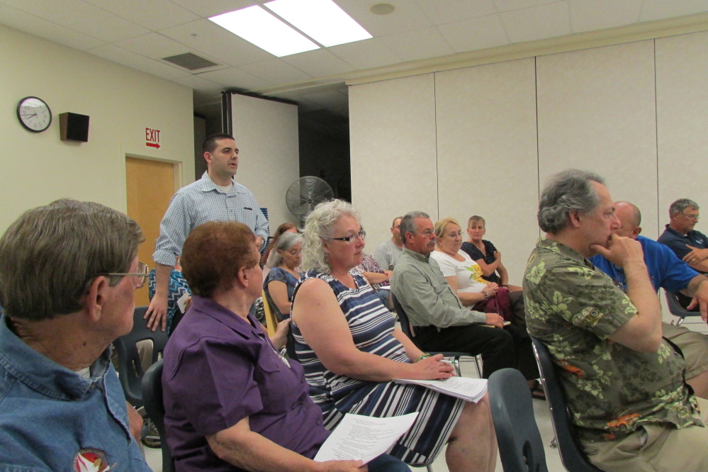 Fairfield Town Manager Josh Reny speaks as residents of School Administrative Disttrict 49 listen at a public hearing Tuesday on the school budget. The board will present budget cuts at a special meeting Thursday night.