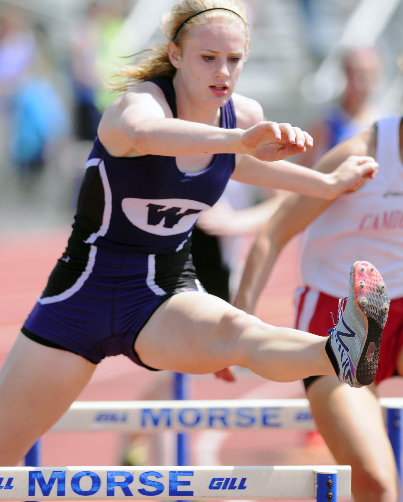 Waterville’s Sarah Shoulta runs the 300 meter hurdles during the KVAC track meet Saturday at McCann Field in Bath.