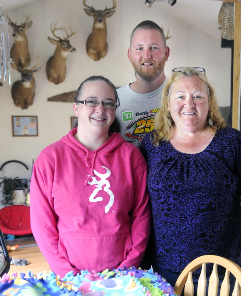 Judy Wildes, right, with her son, Derek Wildes, and his girlfriend, Erica Rollins, at the elder Wildes Augusta home on Sunday. Rollins and Derek Wildes’ son, Mason, was born prematurely and is being treated at Maine Medical Center in Portland.