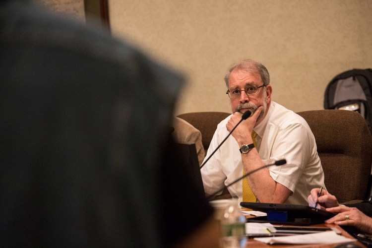 Mayor Alan Casavant listens to public comment at Tuesday night's Biddeford City Council meeting. He told the standing-room-only audience that city officials cannot comment on the investigation of abuse allegations, but want to see justice.