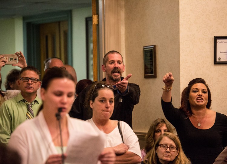 Greg Blouin, center, and Mellisa Luedke, right, object to Biddeford city councilors after Mayor Alan Casavant banged his gavel to close the public comment portion of Tuesday night's emotional council meeting. Residents at the meeting said they were angry and hurt by what they see as a lack of action by councilors and Casavant.