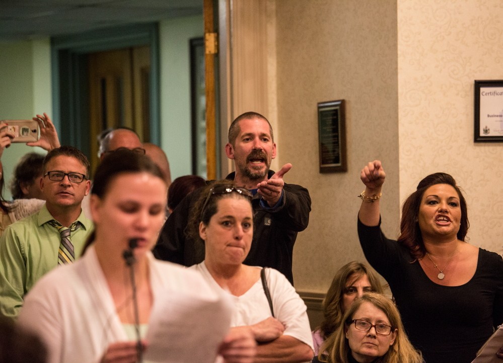  Greg Blouin, left, and Mellisa Luedke, right, object to members of the Biddeford City Council after Mayor Alan Casavant bangs his gavel for Samantha Rocray-Parenteauat to stop speaking, to close the public comment portion the Biddeford City Council meeting in Biddeford, ME on Tuesday.  Whitney Hayward/Staff Photographer