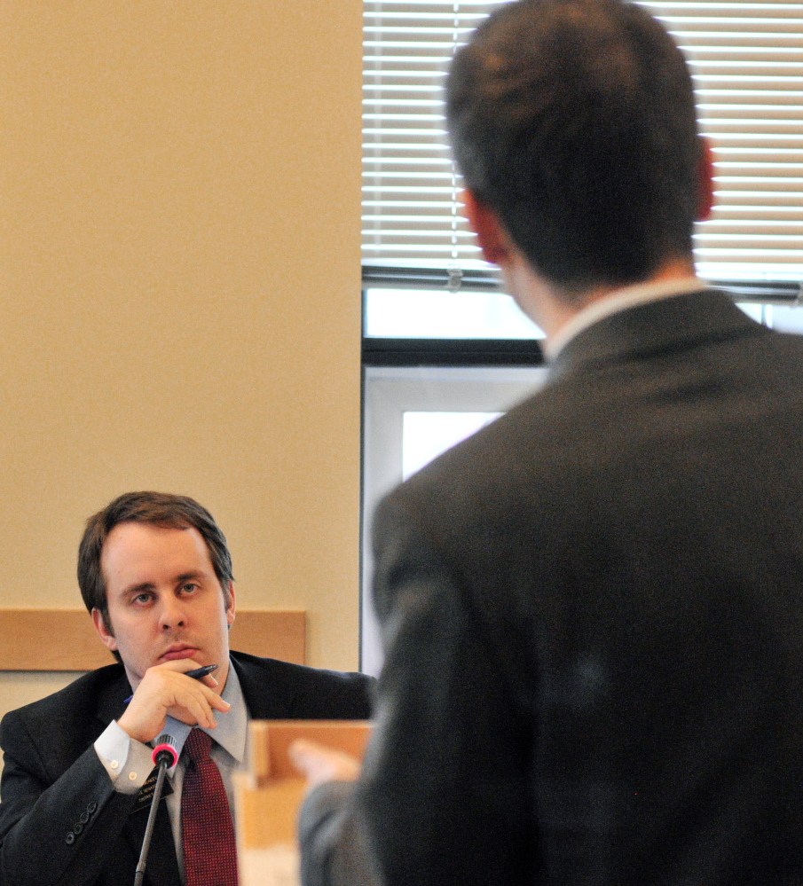 Sen. Eric Brakey, R-Auburn, co-chair of the Health and Human Services Committee, listens as Rep. Scott Hamann, D-South Portland, speaks about child care for foster children.