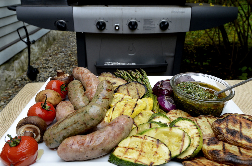 Grilled vegetables and sausages with a chimichurri sauce.