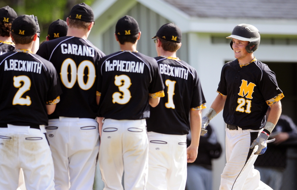 Maranacook teammates greet Cam Brochu at home plate after he hit two-run homer during a game against Waterville on Wednesday in Readfield.