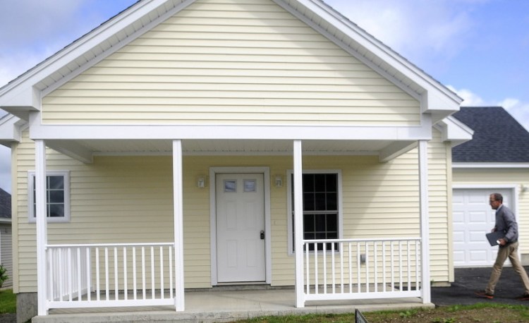 Real estate agent Perry McCourtney shows a vacant home Wednesday at Patriots Point in Augusta. The Augusta affordable-housing development, which has filled its lots slowly since breaking ground in 2008, is being rebranded to focus on veterans, who can use grant money to get discounts on the homes.