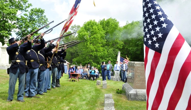 A 20th Maine Volunteer Infantry Regiment re-enactors group performs a 21-gun salute Saturday during a rededication ceremony at the grave of Capt. Charles Billings in Clinton.
