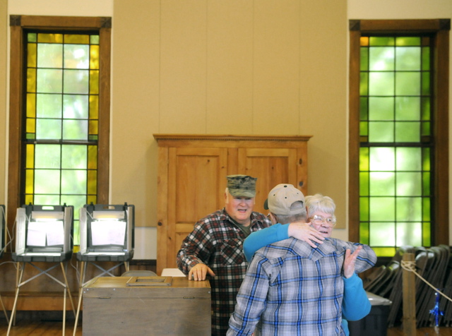 Judy Perkins hugs Ron LaRue on Tuesday after casting a ballot with her husband, Max, at the Mount Vernon Community Center. Towns across Maine are headed to the polls to vote on warrants and school budgets on Tuesday. LaRue serves as the marshal during Mount Vernon’s vote. “I’ll get nervous if I see more than four people here at the same time,” LaRue joked.