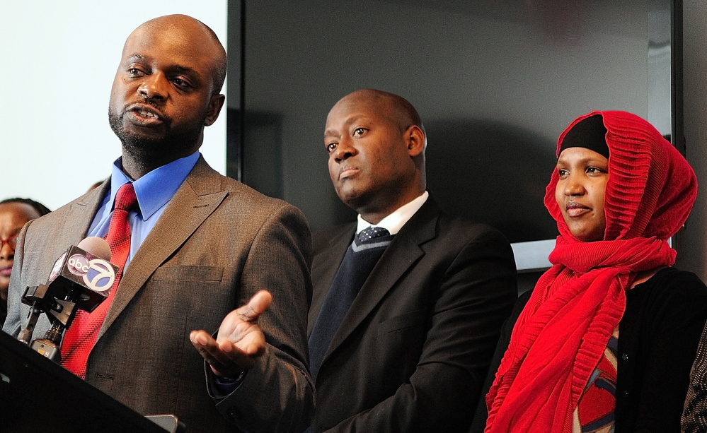 Maxwell Chikuta, left, testifies at a Jan. 10, 2014, State House news conference against a proposal to eliminate General Assistance for asylum seekers. A former General Assistance recipient who sought asylum after fleeing the war-torn Democratic Republic of Congo, he is now a U.S. citizen who has earned bachelor’s and master’s degrees and found a full-time job at Maine Med.