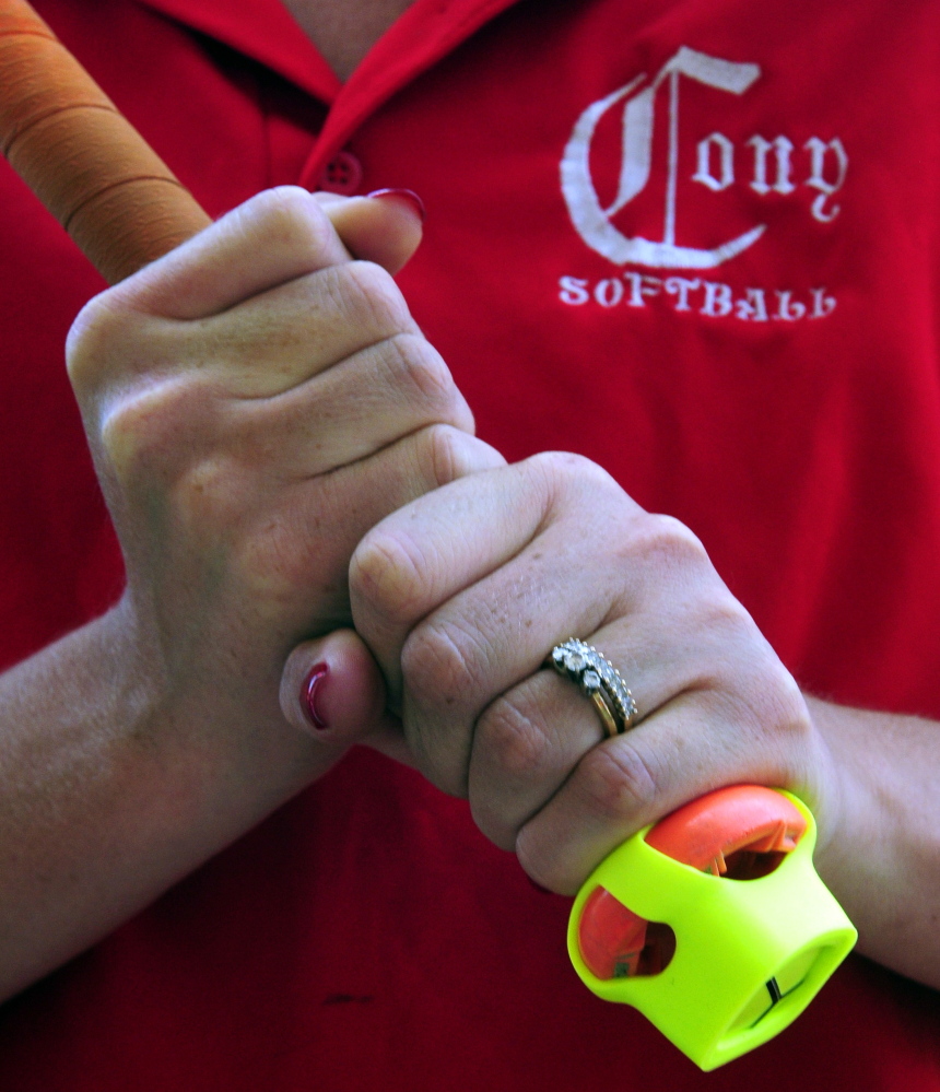 The Zepp sensor is seen on the end of bat held by Cony softball assistant coach Siobhan Murtiff on Thursday at Cony Family Field in Augusta.