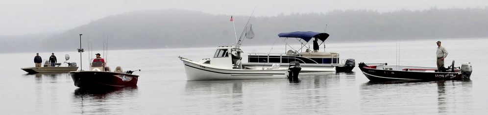 Area volunteer boat owners drift on Tuesday on Great Pond in Belgrade to pick up arriving veterans for the Fishing Extravaganza.