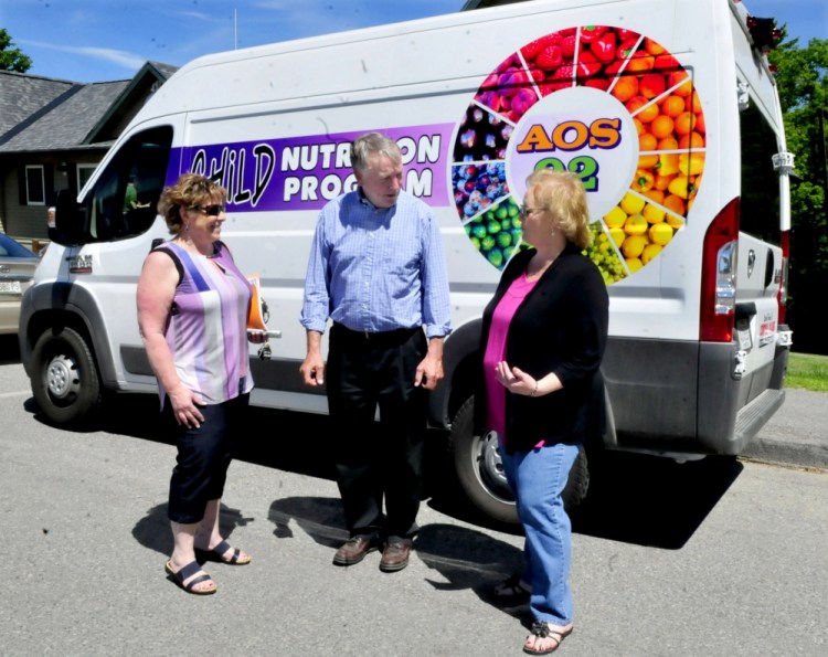 Waterville school officials on Wednesday talk outside a new van that will be used in a food program this summer. From left are Alternative Organizational Structure 92 Finance and Food Director Paula Pooler, Superintendent Eric Haley and Food Services Supervisor Barbara Bonnell.