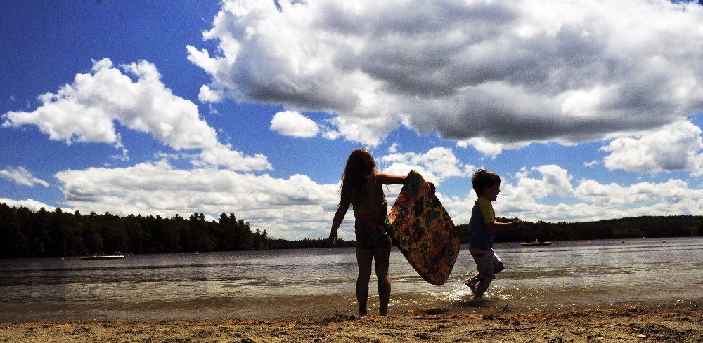Shae LePage, left, and Griffin LePage splash on Friday in Maranacook Lake at the Readfield Town Beach in Readfield.