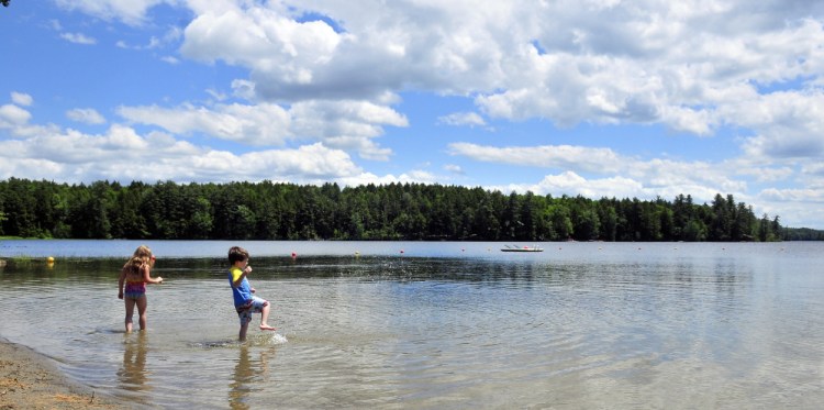 Shae LePage, left, and Griffin LePage splash on Friday in Maranacook Lake at the Readfield Town Beach in Readfield.