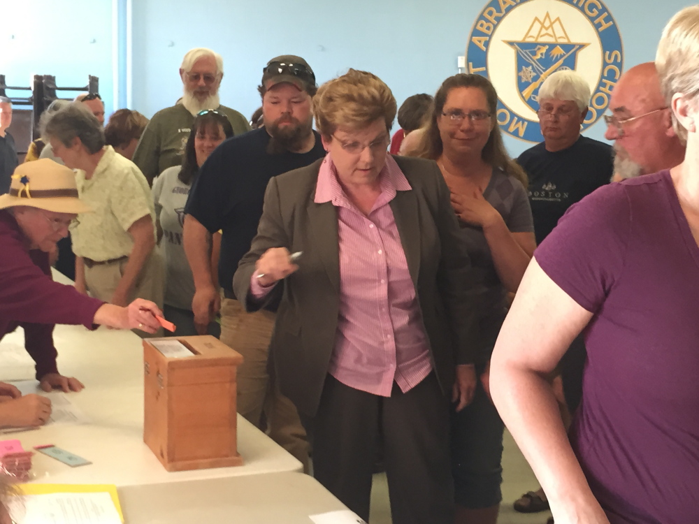 Incoming Superintendent Susan Pratt votes along with others at the School Administrative District 58 meeting Monday night where a $9.4 million budget was approved.