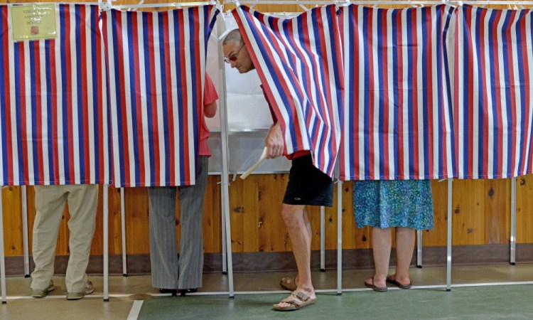 Staff photo by Michael G. Seamans
Voters cast RSU 18 school budget ballots in the voting booths at the Belgrade Community Center on Tuesday.