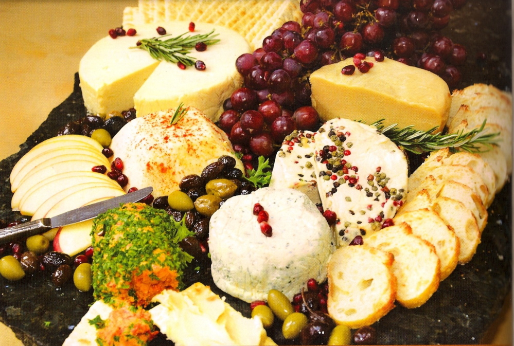 An assortment of cheeses from Miyoko Schinner’s “Artisan Vegan Cheese.” From top left: an air-dried Gouda, a hard Gruyere, a brie with whole peppercorns, a Boursin, a sun-dried tomato and garlic cream cheese and a meltable Muenster.