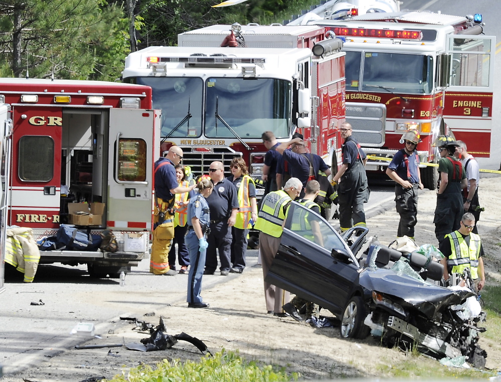 Law enforcement and emergency personnel stand at the corner of Intervale and Penny roads in New Gloucester after a head-on crash Wednesday involving a SAD 15 school bus and a car, whose driver was seriously injured. The bus driver suffered minor injuries, and all of the 3rd- and 4th-graders who were on the bus got out safely.