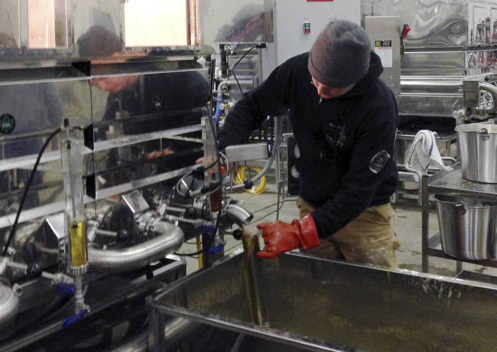 Jon Cox of East Charleston, Vt., checks the density of maple syrup being boiled at the Sweetree LLC plant in Island Pond, Vt., in March. Vermont continues to lead the nation by far, producing most of the syrup in the country, followed by New York and Maine.