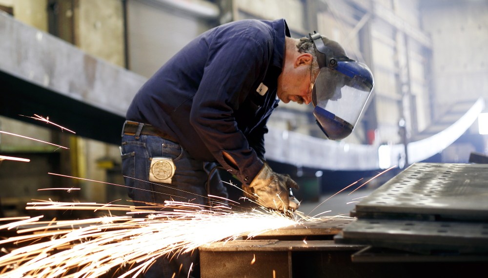 Casco Bay Steel Structures Inc., has used commercial loans from Bangor Savings Bank to expand business and increase productivity. Dana Ouellette, who was the second employee hired and has worked at the company for 18 years, grinds splice blades for bridge construction.
