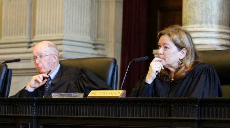 Chief Justice Leigh Saufley, right, joined by Justice Donald Alexander, listen to arguments before the Maine Supreme Judicial Court, Friday during a hearing on the issue of LePage's attempt to veto 65 bills after lawmakers said they already became law. Joel Page/Staff Photographer