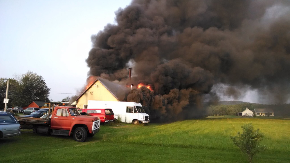 Contributed photo/

A fire Wednesday at Phil’s Garage & Salvage destroyed a garage and two vehicles.